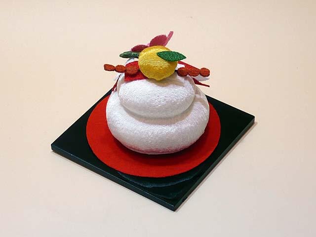 Non-edible decorative kagami mochi on a lacquer plate
