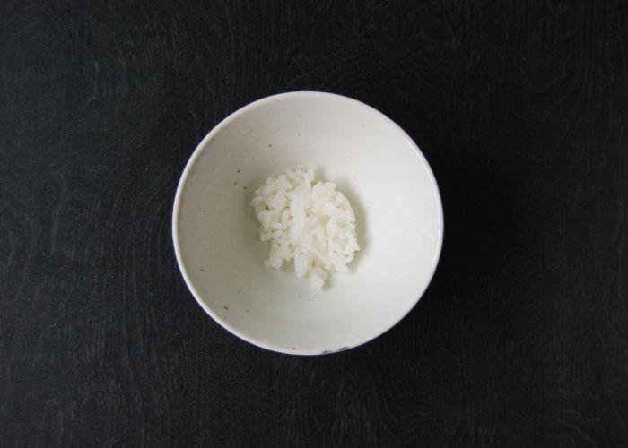 Japanese rice in a bowl on a black background