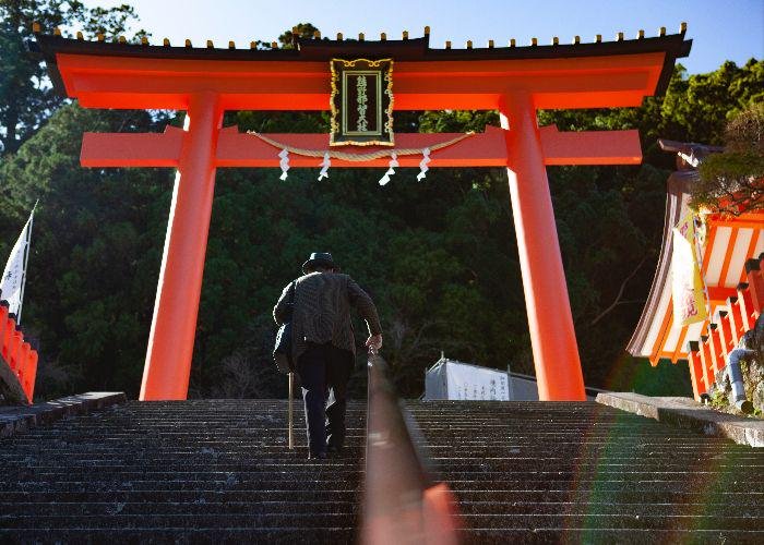 A man walks up the steps to a shrine in Wakayama