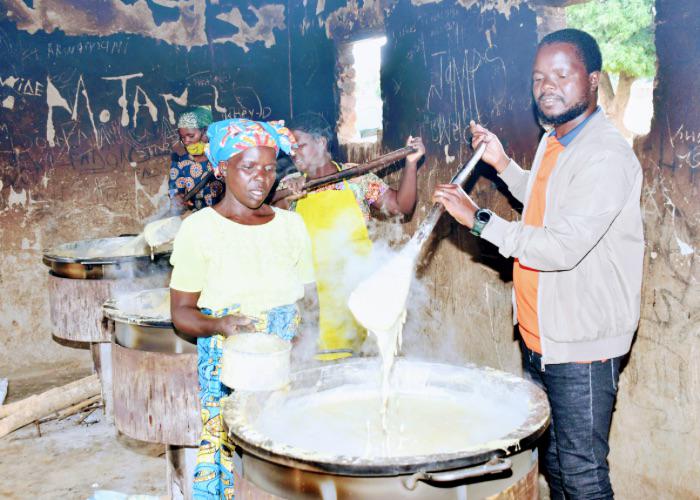 volunteers and school staff preparing school meals in large stoves