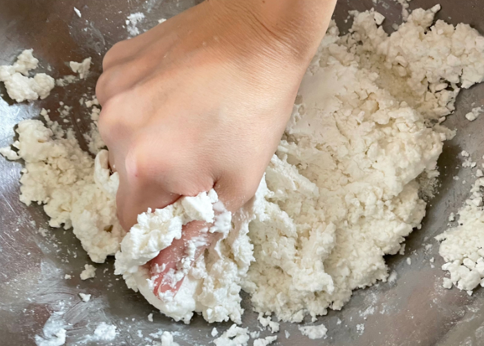 Kneading dango dough in an aluminum bowl