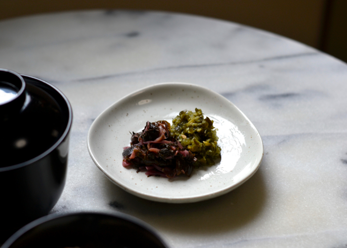 Purple shibazuke and green shisonomi pickles in a dish