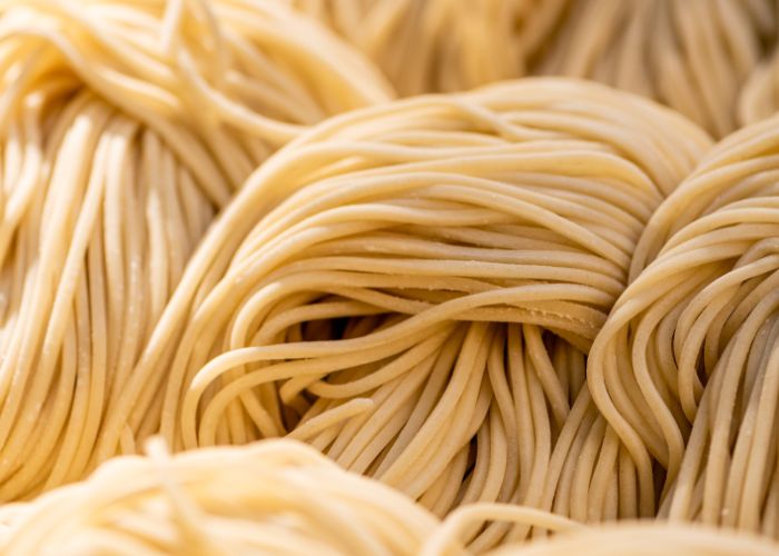 A very close up shot of bundles of dry ramen noodles ready to be cooked
