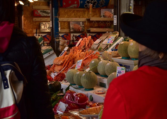 Melons lined up at a market.