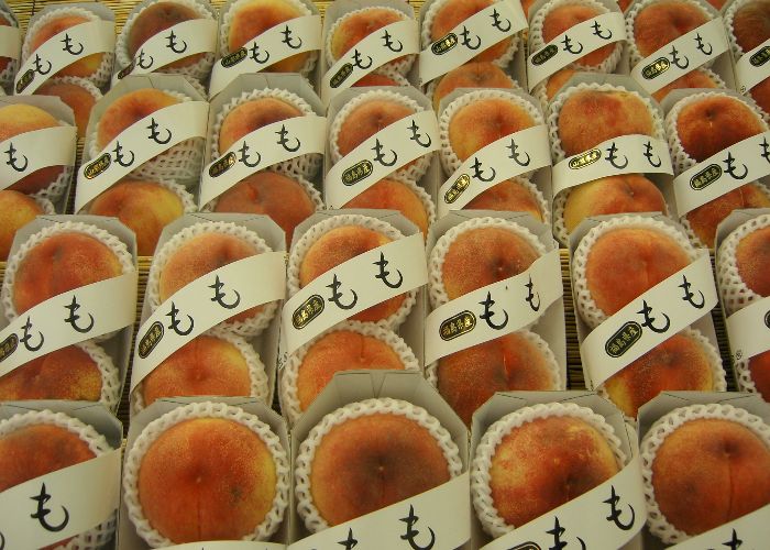 Rows of neatly packaged Japanese white peaches from Fukushima