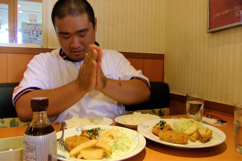 Man saying itadakimasu at a restaurant before he eats