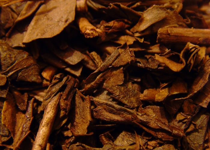 A close up image of dried brown tea leaves