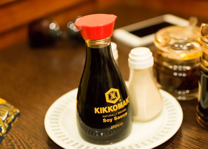 A bottle of Kikkoman Japanese soy sauce on a table
