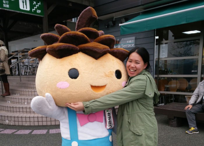 Making friends with the locals on a solo trip to Japan, Lucy hugging a character