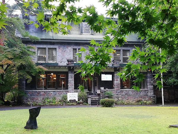 Charming stone restaurant building surrounded by lush greenery
