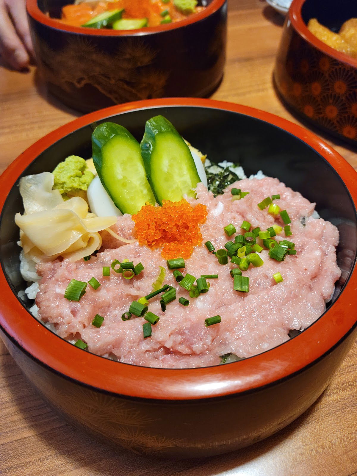 Delicious tuna bowl with sushi rice, cucumber, and garnish