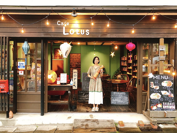 Charming Cafe Lotus facade with inviting warm lighting