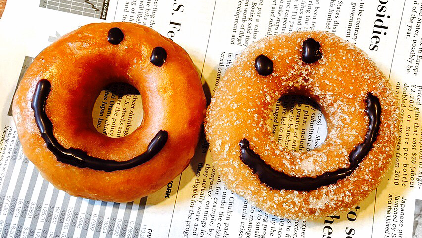 Smiley face donuts on a newspaper background
