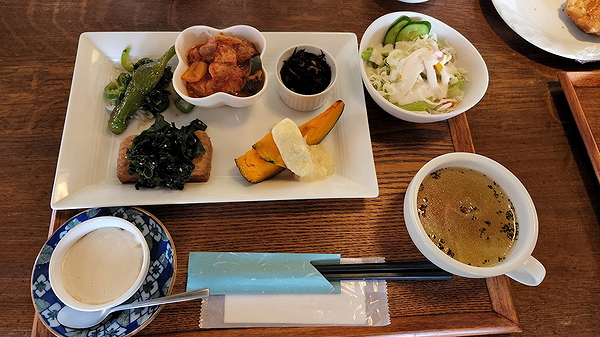 Traditional Japanese meal set with various dishes on wooden table