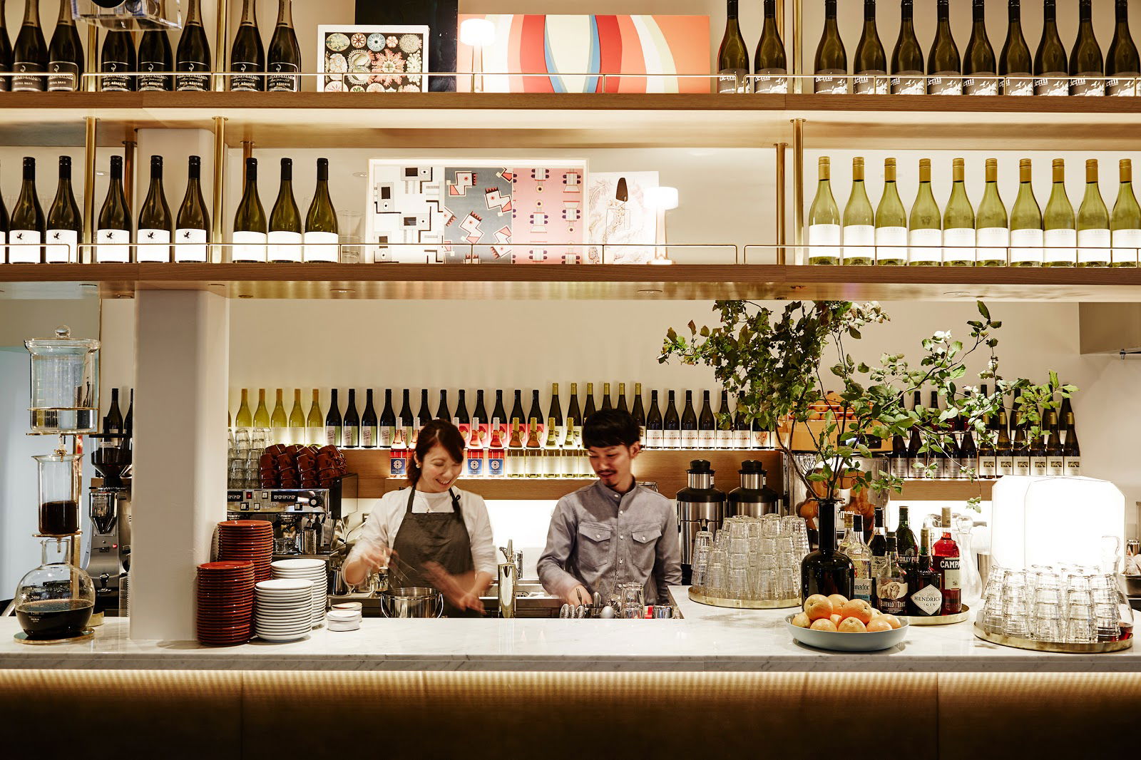 Bartenders serving drinks at modern restaurant bar