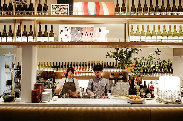 Bartenders serving drinks at modern restaurant bar