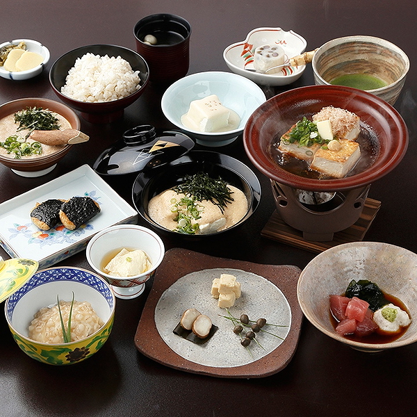 Traditional Japanese meal with diverse dishes and steaming hotpot