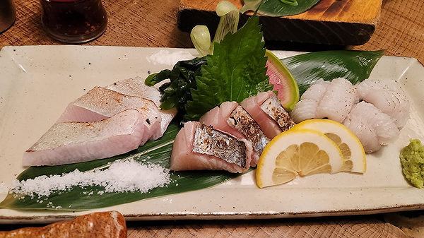Exquisite sashimi platter with fresh wasabi and lemon slices