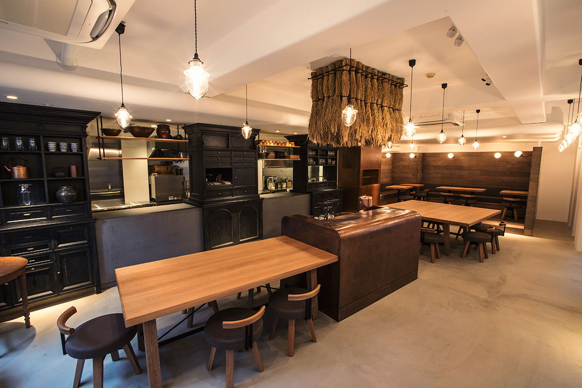 Modern restaurant interior with wooden tables and warm lighting