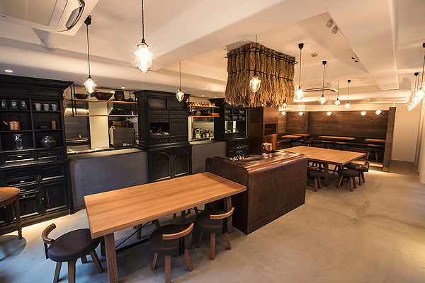 Modern restaurant interior with wooden tables and warm lighting