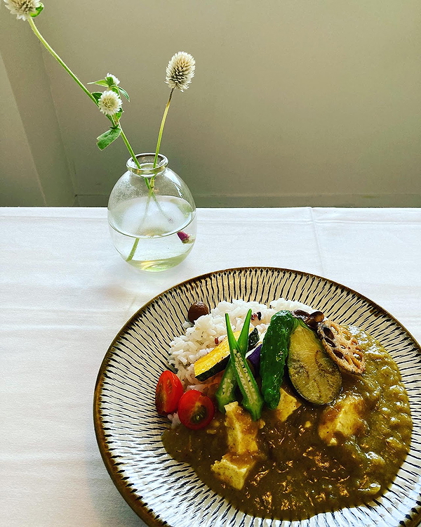 Vegan curry with rice and vegetables on a restaurant table