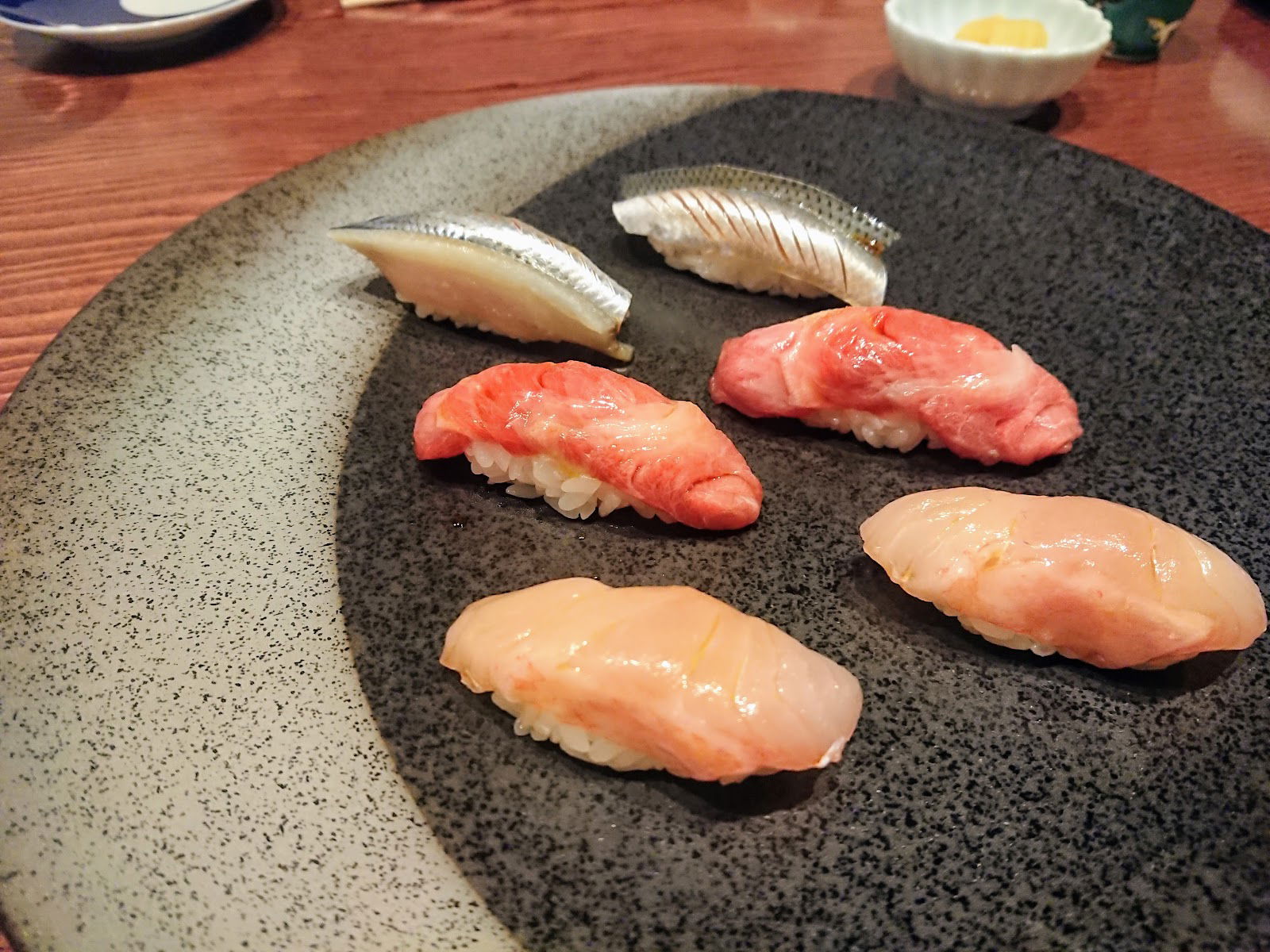 Three nigiri sushi types at Sushi Arai (Niigata), featuring fish served on a bed of rice.