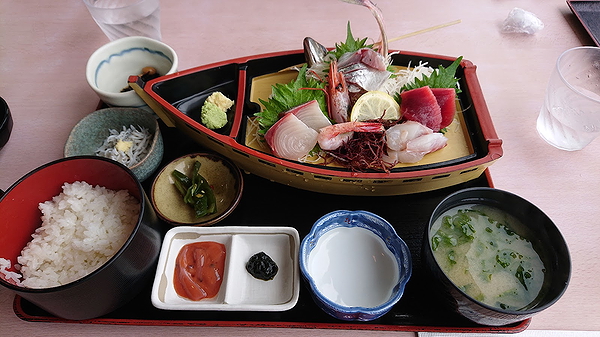 Traditional Japanese sashimi boat with assorted seafood and rice