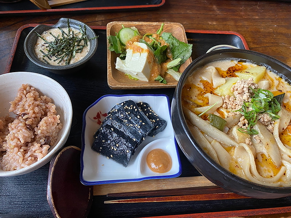 Traditional Asian noodle soup with rice and side dishes