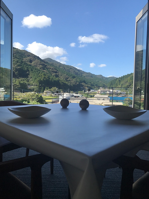 Scenic restaurant view of mountains through open glass doors
