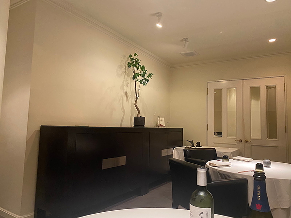 Elegant restaurant interior with minimalist decor and wine on table