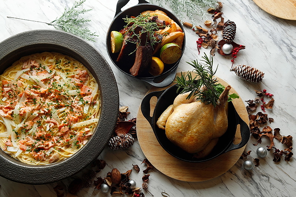 Rustic marble table with pasta, roasted chicken, and vegetables
