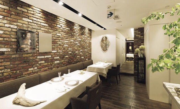 Cozy brick-walled restaurant interior with elegant table setting