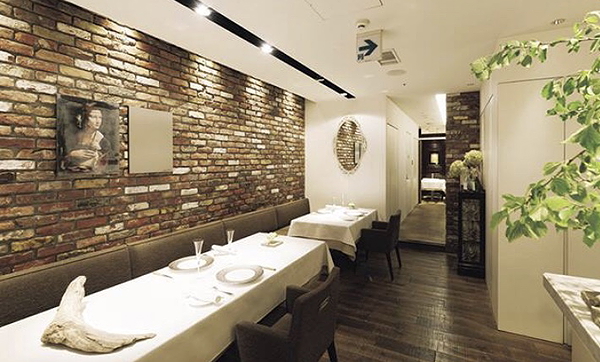 Cozy brick-walled restaurant interior with elegant table setting