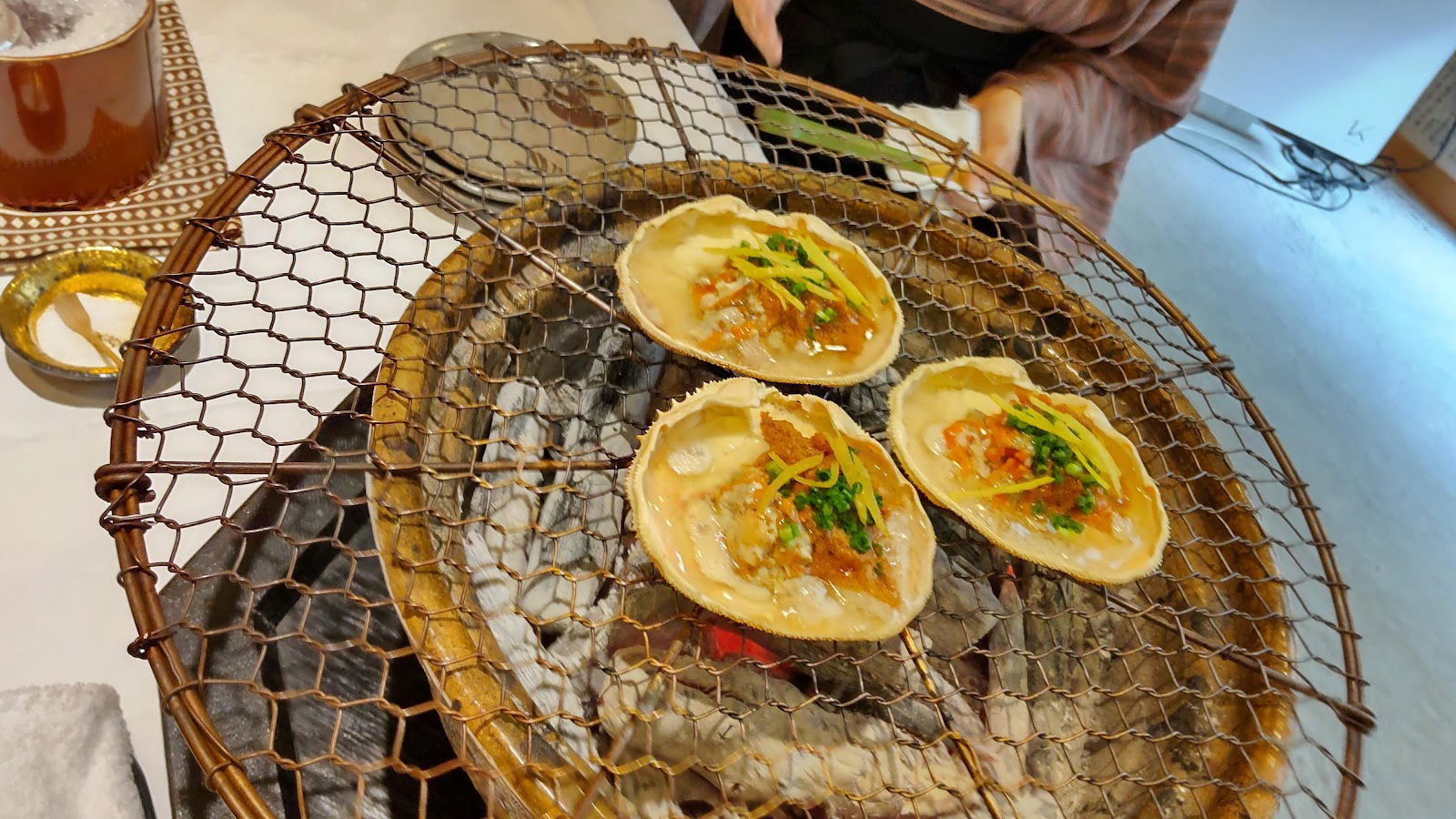 Gourmet seafood dish cooking on traditional Japanese grill