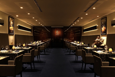 Elegant fine dining restaurant ambiance with dim lighting and set tables