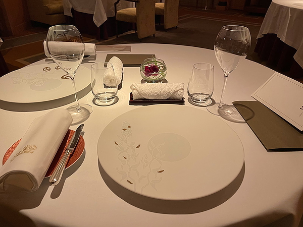 Elegant table setting at upscale restaurant with fine dining ambiance