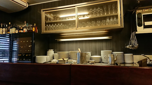 Elegant restaurant interior showcasing neatly stacked dishes and glassware
