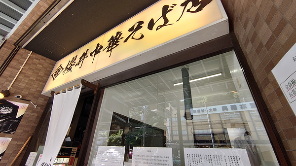 Cozy restaurant entrance with traditional Japanese signage in urban setting