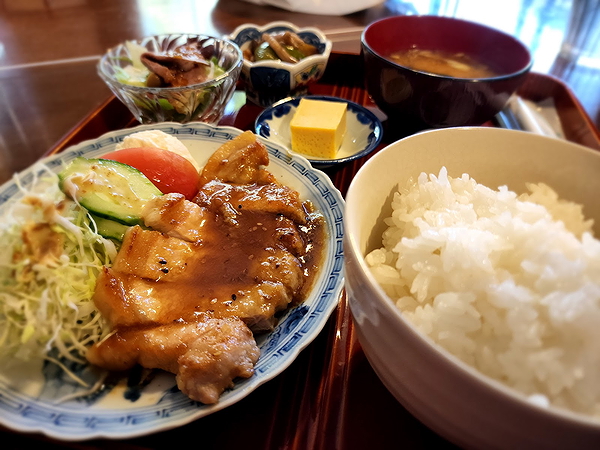 Traditional Japanese meal with rice, miso soup, and grilled chicken