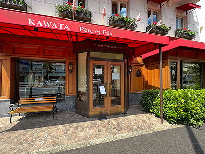 Charming bistro entrance with red canopy and wooden door