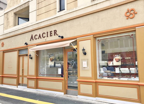 Charming restaurant exterior with elegant facade and window displays.