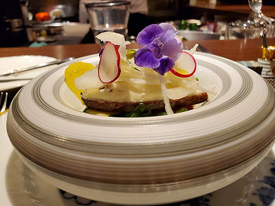 Gourmet dish with edible flower in elegant restaurant setting