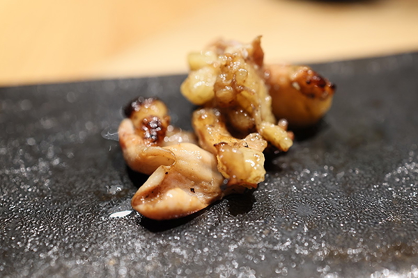 Grilled delicacy on black stone plate at gourmet restaurant