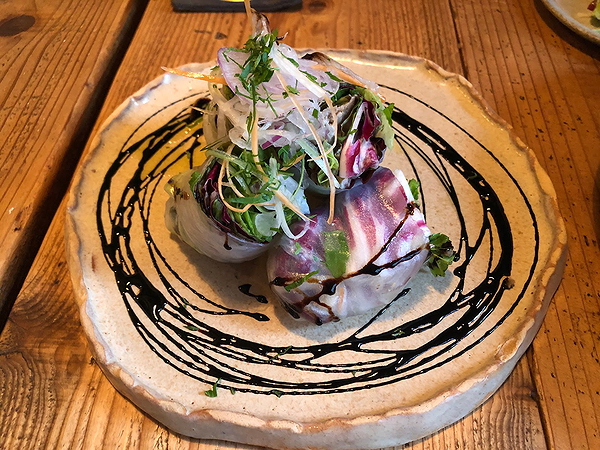 Gourmet dish with fresh herbs and balsamic glaze on a ceramic plate