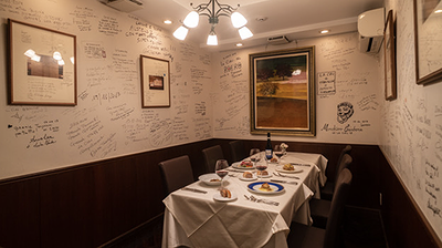 Elegant restaurant dining room with art-adorned walls and a set table