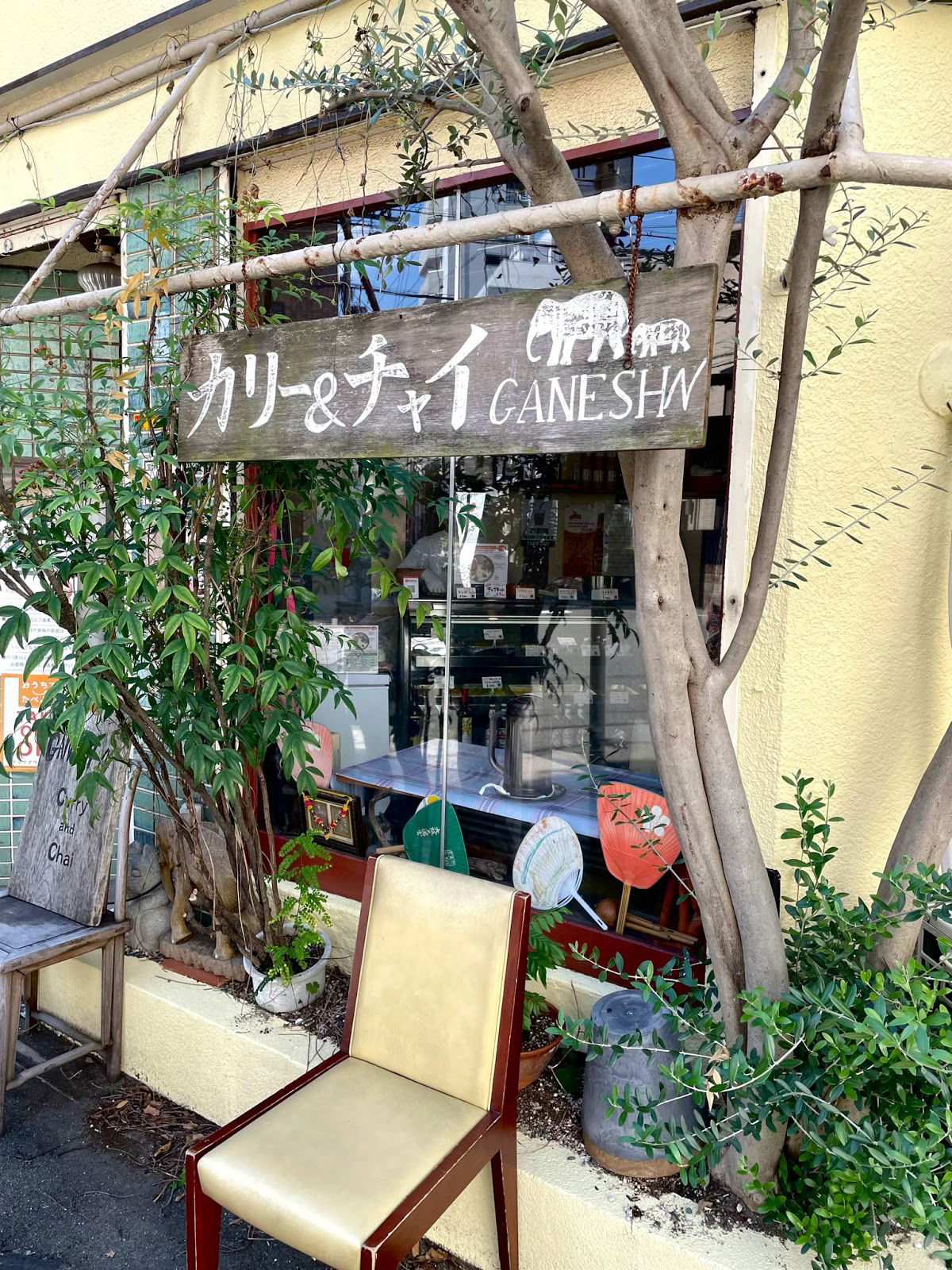 Cozy curry and chai restaurant exterior with wooden sign