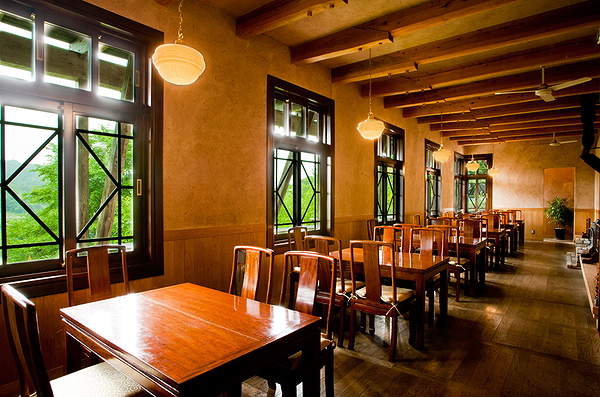 Elegant rustic dining area with natural light and wooden furniture