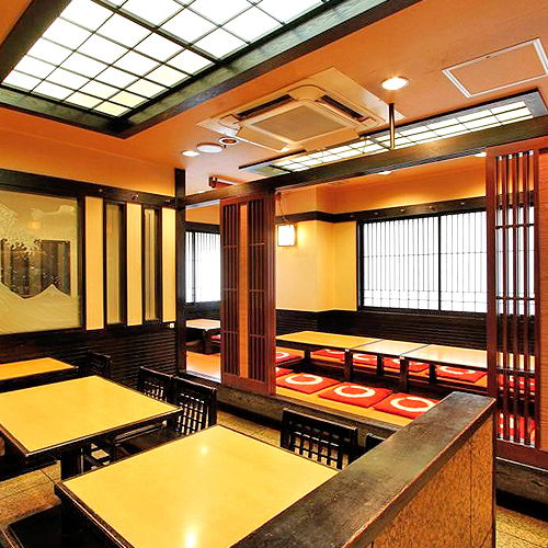 The traditional interiors of MASU‐KAME, including some tatami-mat seating.