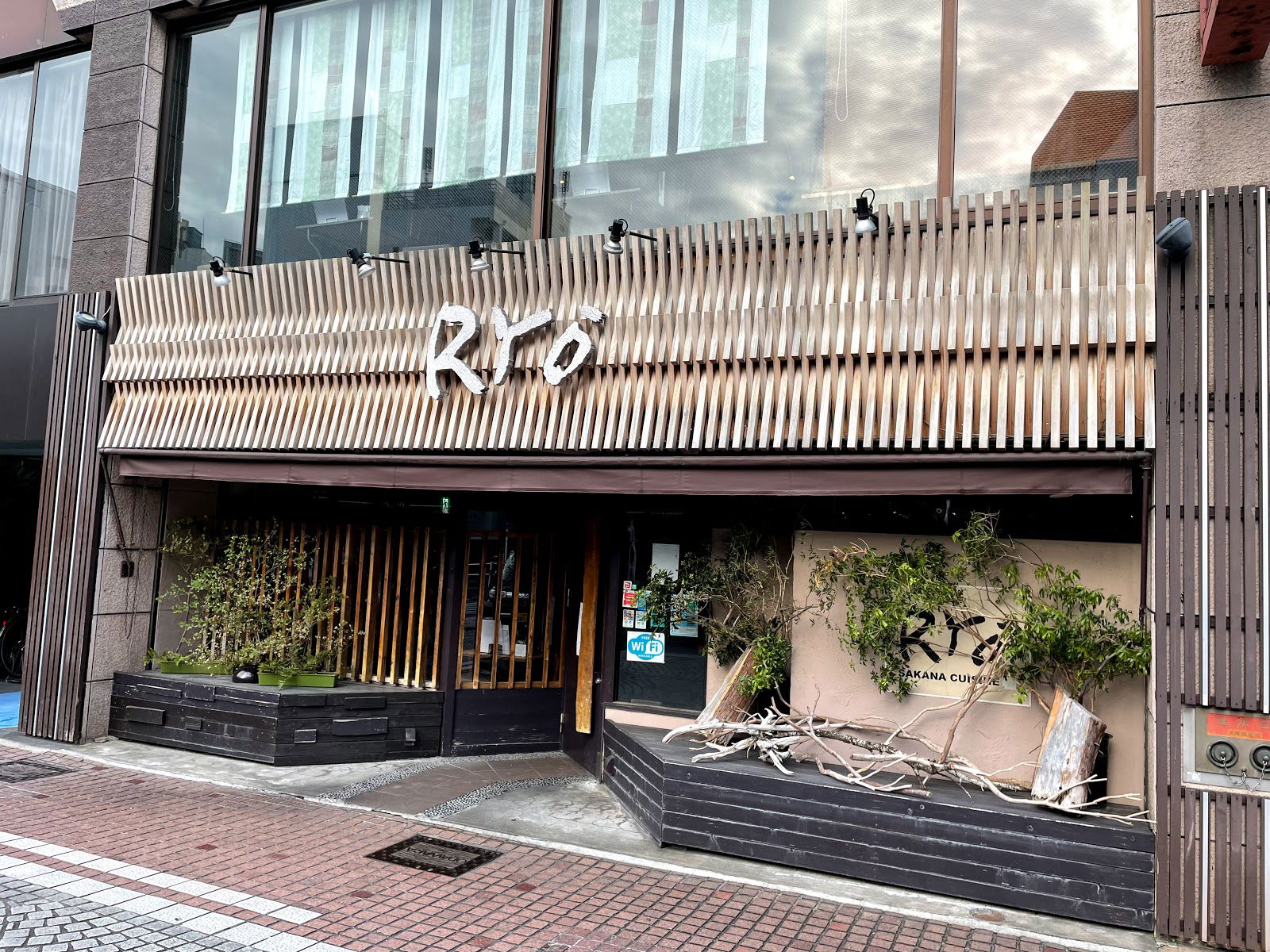 Contemporary restaurant facade with wooden accents and urban street view