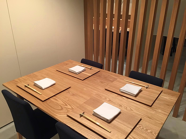 Modern restaurant table setting with wooden decor and minimalistic design